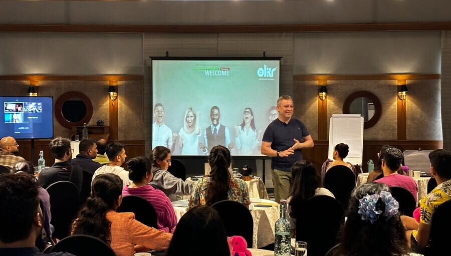 Nikhil Maini — OKR Keynote Speaker on stage at a leadership event